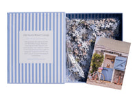 Showing puzzle book open with pieces
erfect for puzzle and fine art photography enthusiasts alike, Gray Malin Nantucket 1000 Piece Book Box Puzzle features "Old North Wharf Cottage, Nantucket" from Gray’s best-selling collection, 1000 pieces