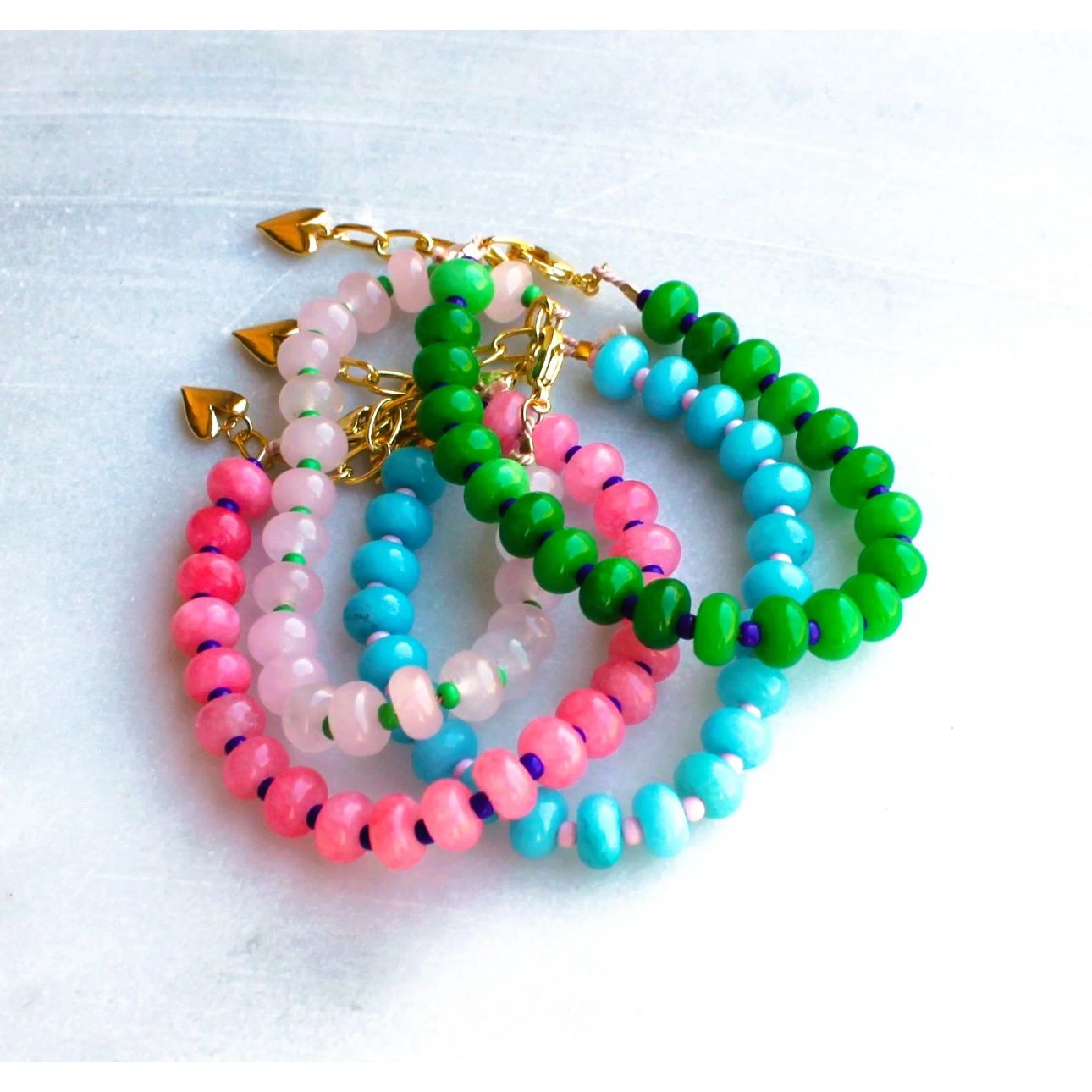 Gorgeous colorful stone candy jade is hand strung to create this beaded bracelet.  Layer these up or wear them alone, they are perfect for a stylish pop of color to your outfits! 
__________________
D E T A I L S
•Colorful jade strung by hand 
•18kt gold filled closure and heart charm
•Available in a 6.5 inch length with a 1.5 inch extender