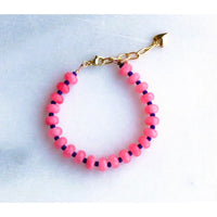 Bright pink and navy bracelet shown