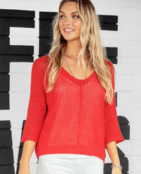 This soft, red, lightweight, and breathable top is knit with a tuck stitch for an airy feel. The super-boxy fit and deep V-neck are both flattering and cooling. Knitted from our cotton-blend yarn, it features 3/4 sleeves, a ribbed hem, and a center seam for a casual touch.
Composition: 60% cotton, 40% acrylic
 
SIZE	CHEST WIDTH (CM)	LENGTH (CM)
X/S	2-4	56.50	52.75
S/M	6-8	59.00	55.00
M/L	10-12	61.5