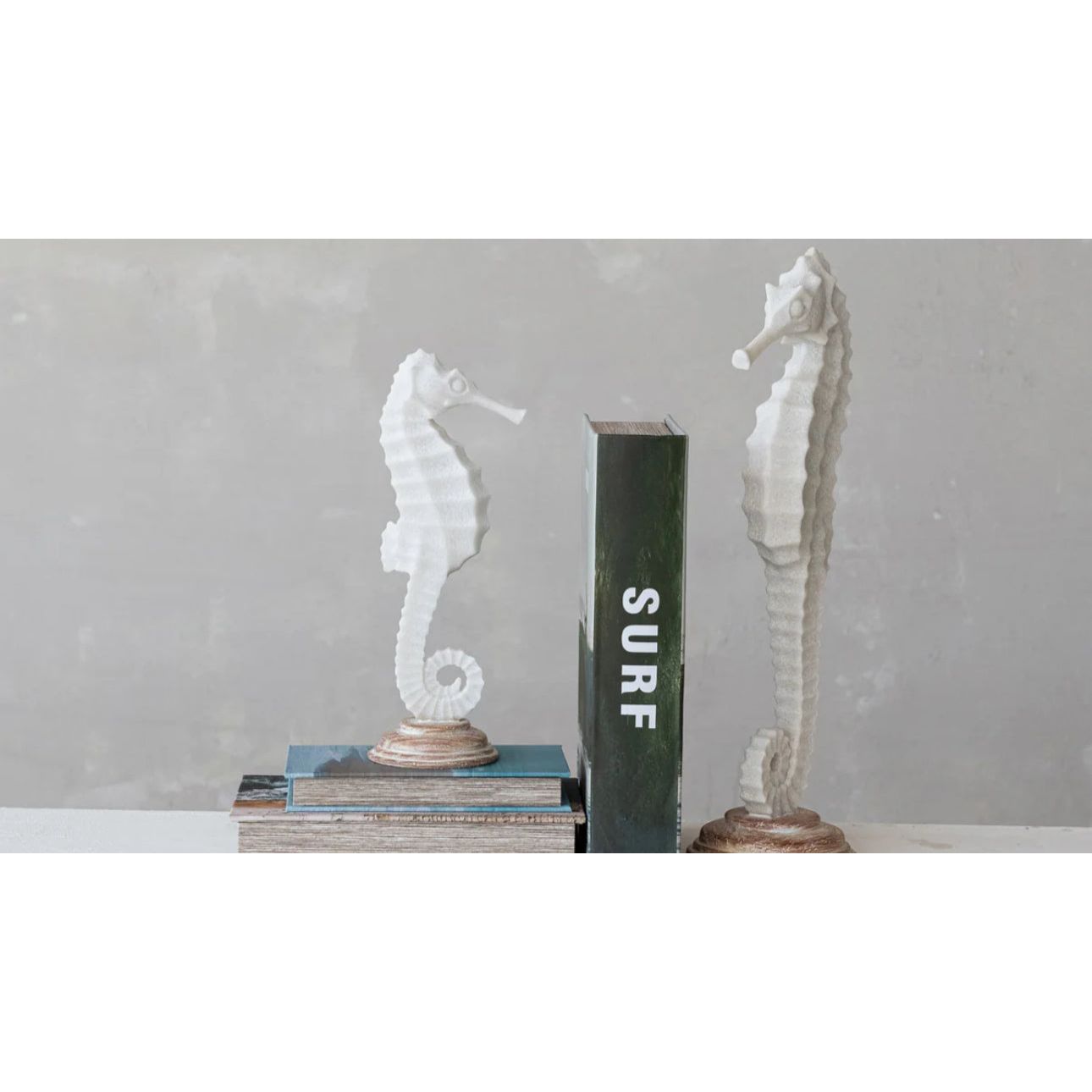 Showing both sides a of seahorse state as book ends 
Coastal elegance meets rustic home decor. Sand finished resin seahorses statue on wood base. 12.5” tall large 18” tall