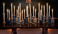 Create a show stopping table scape with these hand painted and hand sculpted candle sticks  to bring a one of a kind look to your home decor.  These candle sticks are designed to mix and match with other colors and sizes to create your best table scape yet   
Table with multiple candle sticks with lit candles shown 
Hand wash
Large-3.5 diameter x 10.75” high 
Medium-3.5 diameter x 7.5” high