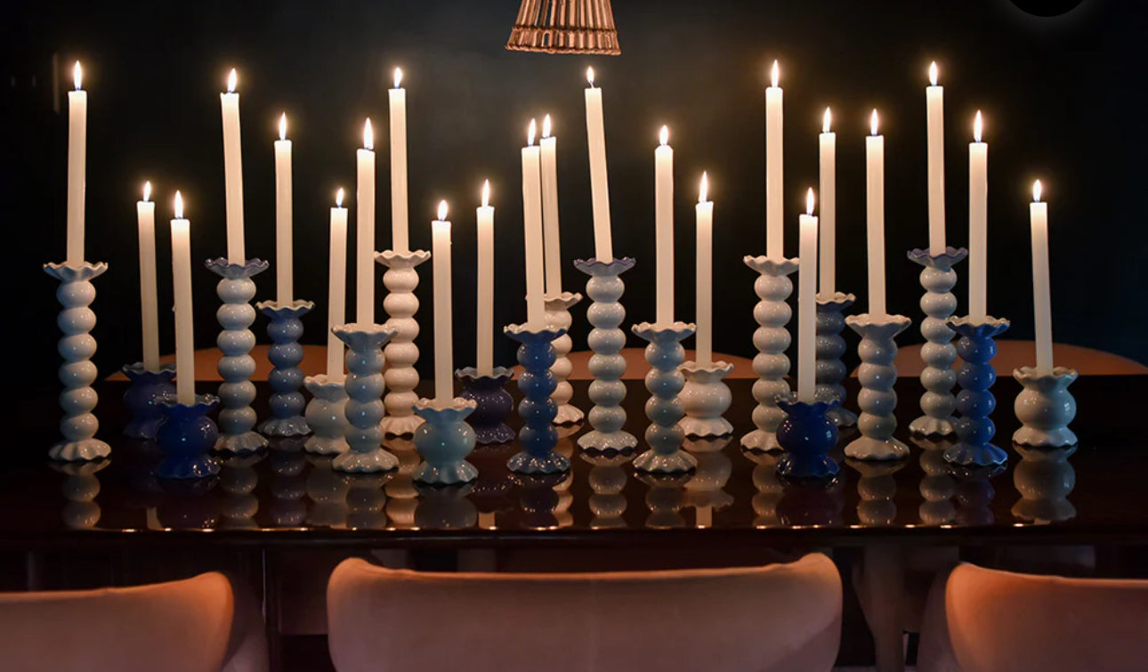 Create a show stopping table scape with these hand painted and hand sculpted candle sticks  to bring a one of a kind look to your home decor.  These candle sticks are designed to mix and match with other colors and sizes to create your best table scape yet   
Table with multiple candle sticks with lit candles shown 
Hand wash
Large-3.5 diameter x 10.75” high 
Medium-3.5 diameter x 7.5” high