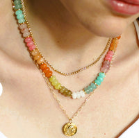 Necklace on women’s neck Gorgeous, natural dyed multi colored jade jade, 5x8mm beads - turquoise, white, yellow, pink, orange, light brown beads 
•Adorned with 14kt gold plated accents
•Beaded by hand just for you
Water friendly
18”
Made in USA
Handmade