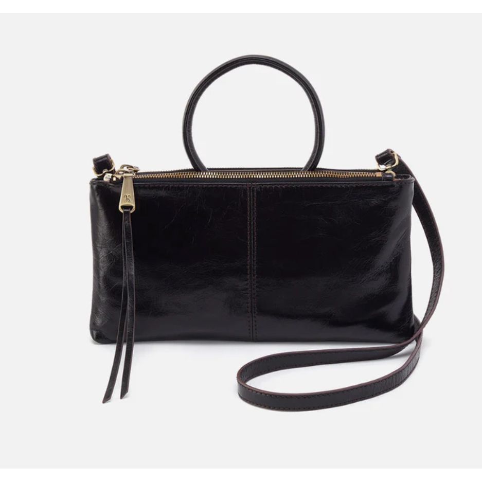 Inspired by our best-selling Sable wristlet,
this crossbody has the signature round
handle you know and love and a removable
strap for two looks in one.  Shown in black