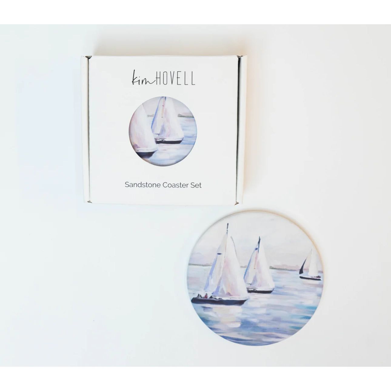 3 sailboats on the water on the coasters. 
Made to keep your tables scratch-and-moisture-free, our sandstone coasters have a cork backing, so you can use them on any surface.
Kim Hovell Original Artwork: Ebb and Flow
Diameter: 4.25"
Thickness: 0.25"
Made of sandstone with a cork pad backing
Not dishwasher safe