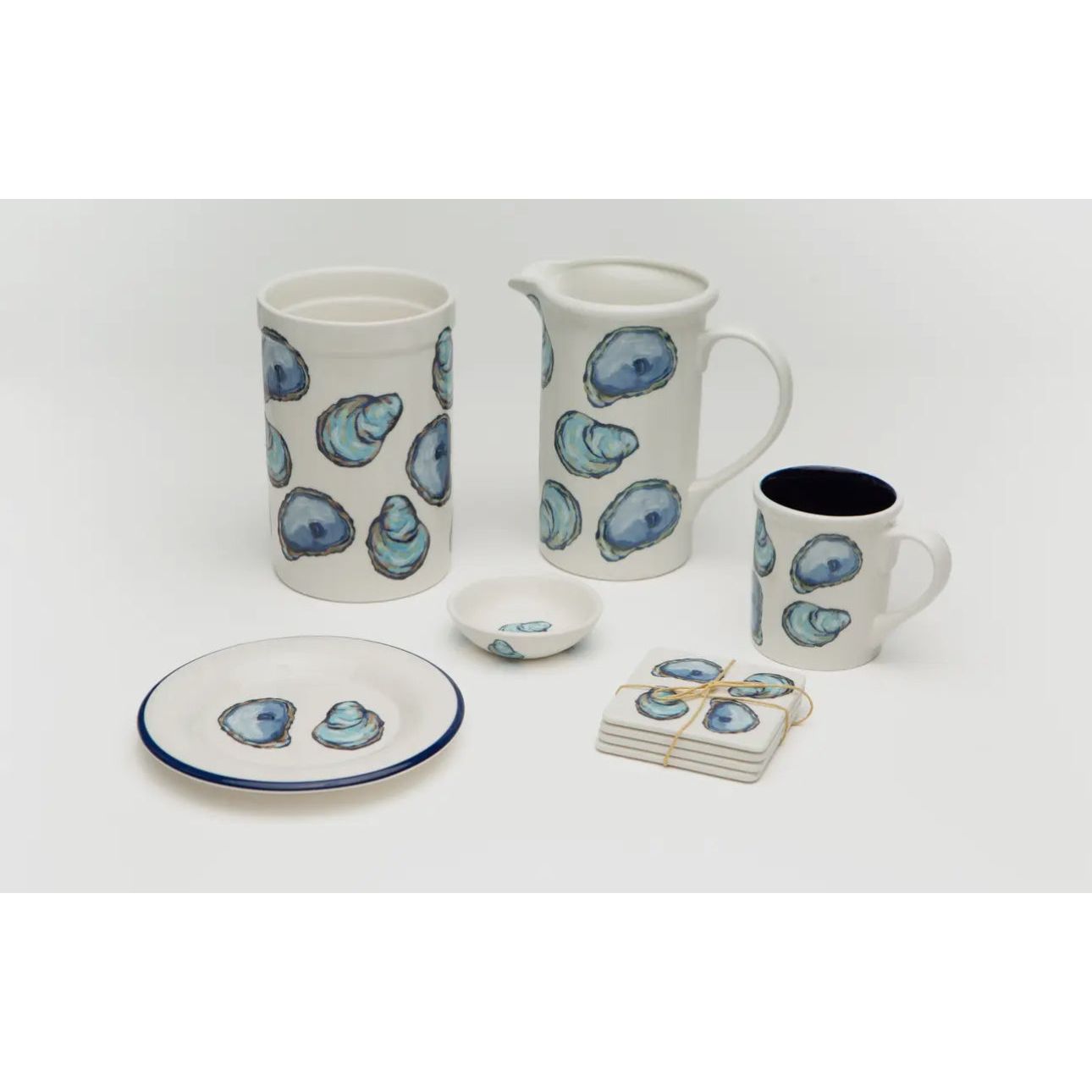 No shuck needed for this coastal oyster see.  White base with purple and blue painted  oysters.  Whole collection shown. Croc, pitcher, coaster, mug, tasting dishes