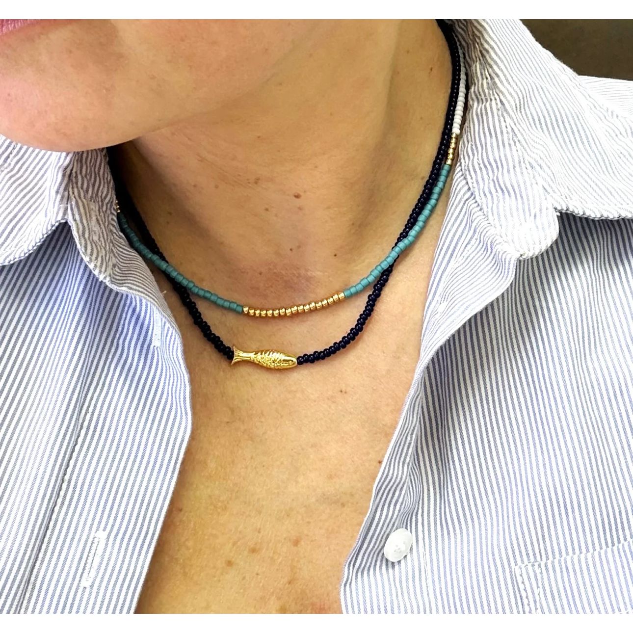 Turquoise necklace shown with fish necklace