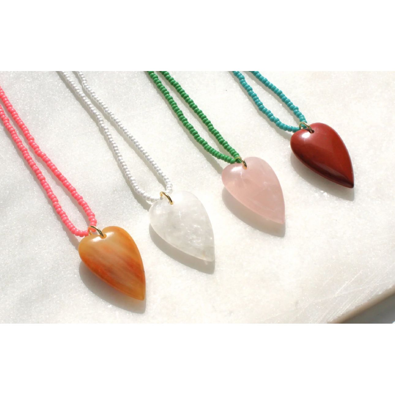Fall in love with our heart-shaped gemstone necklaces. Made with hand strung beaded necklaces, these trendy pieces are perfect for layering or wearing solo. A must-have for lovers of statement jewelry and romantic accessories. Perfect for everyday wear or as a gift!
_______________
DETAILS
•Gemstone pendant in your choice of stone
•Hand strung beaded necklace with tiny glass seed beads
Made in USA