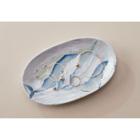 Dish shown with jewelry on it