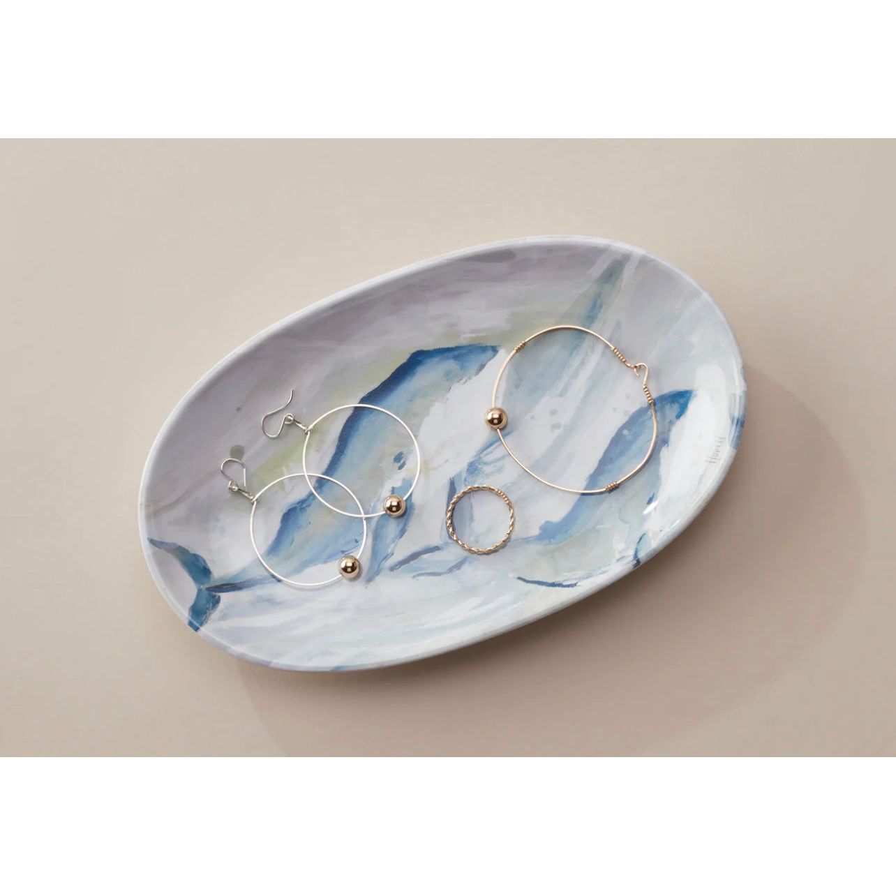 Dish shown with jewelry on it
