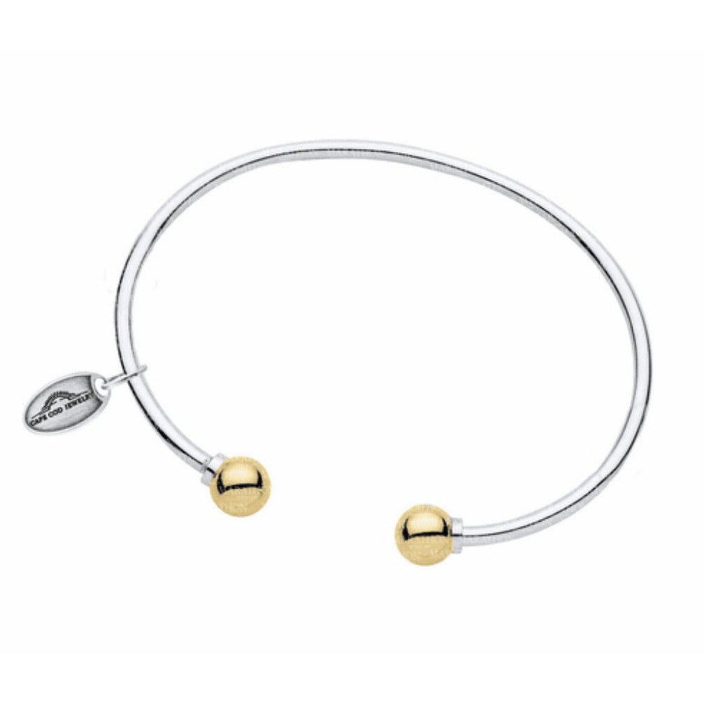 LeStage's genuine Cape Cod Bracelet, with its simple but stylish design is a favorite for all ages!
A unique spin on the classic look -- this cuff features two sterling silver or gold balls on each end.  This bracelet is great to wear alone or add to your Cape Cod Jewelry collection. 
Sterling Silver and 14k Gold shown 
Made in USA