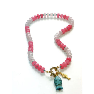 Add a splash of charm to your look with this playful beaded necklace, featuring alternating shades of soft pink and bold rose beads. Centered with a unique turquoise fish charm and a delicate gold fish pendant, this piece brings a whimsical, coastal-inspired flair to your outift 
16 or 18”



•Gorgeous, natural dyed jade, 5x8mm & adorned with glass seed bead accents 
•Gold Filled sailor clasp with a gold plated & turquoise