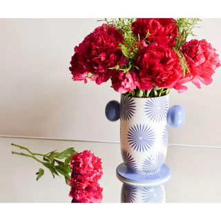 A white vase with blue starburst designs and blue handles filled with red flowers

Let blue blossom in your home decor with our artful, hand painted vases.  


Dishwasher Safe

Small-40oz  Dimensions: 4in Diameter x 7in H

Large 80 oz 