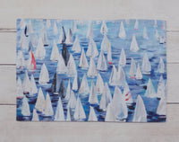 These 100% cotton placemats are reversible. The front side has sailboats all over and the reverse is a dark blue with a line of sailboats. 