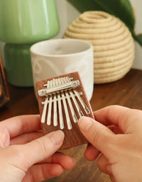 Heard in music around the world, the kalimba creates an unmistakable and ethereal sound. Our pocket-sized version has a sapele wood sound board and 8 steel keys for the best playing experience. Includes sheet music, tuning instructions and a guide. Tune before using.
Design: KDT
Materials: sapele wood, steel
Packaging: color box
Dimensions: 2.75" x 2" x 1" / 7 x 5,3 x 2,7 cm