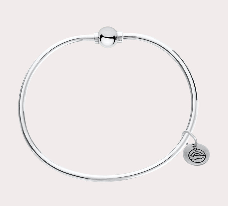 The original design of the Cape Cod Jewelry®️ line, with a sterling silver bangle and single ball available in sterling silver, 14k yellow gold.  Silver shown 