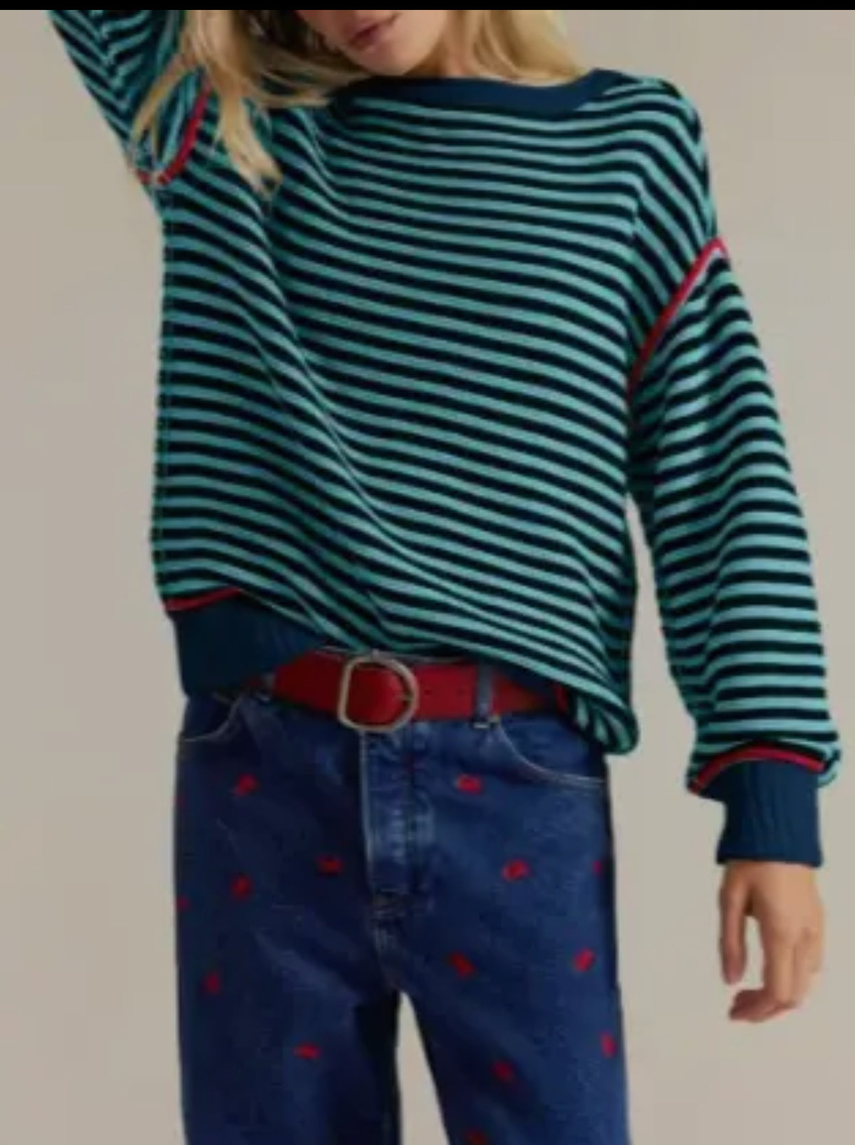 This over sized sweater, with drop shoulders is a customer favorite.  The repeating navy and green stripes with the red pipping give it a fun pop of color. 