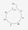 Shell charm bracelet in silver shown laying out with adjustable length 