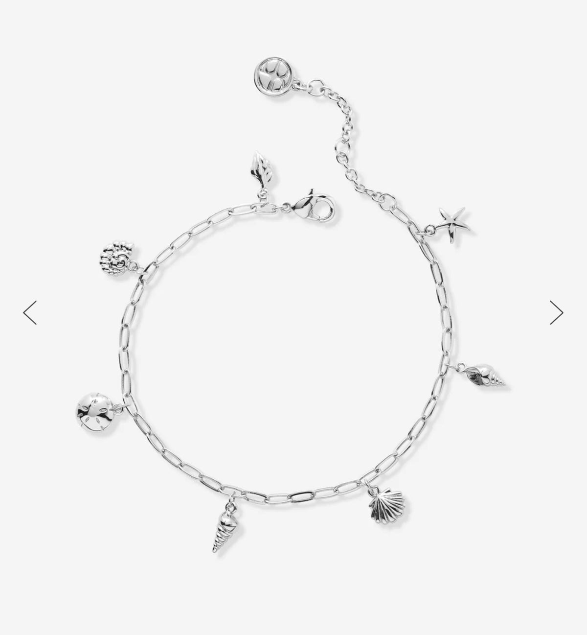 Shell charm bracelet in silver shown laying out with adjustable length 