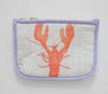 Red lobster shown on light background with purple pipping on edges 