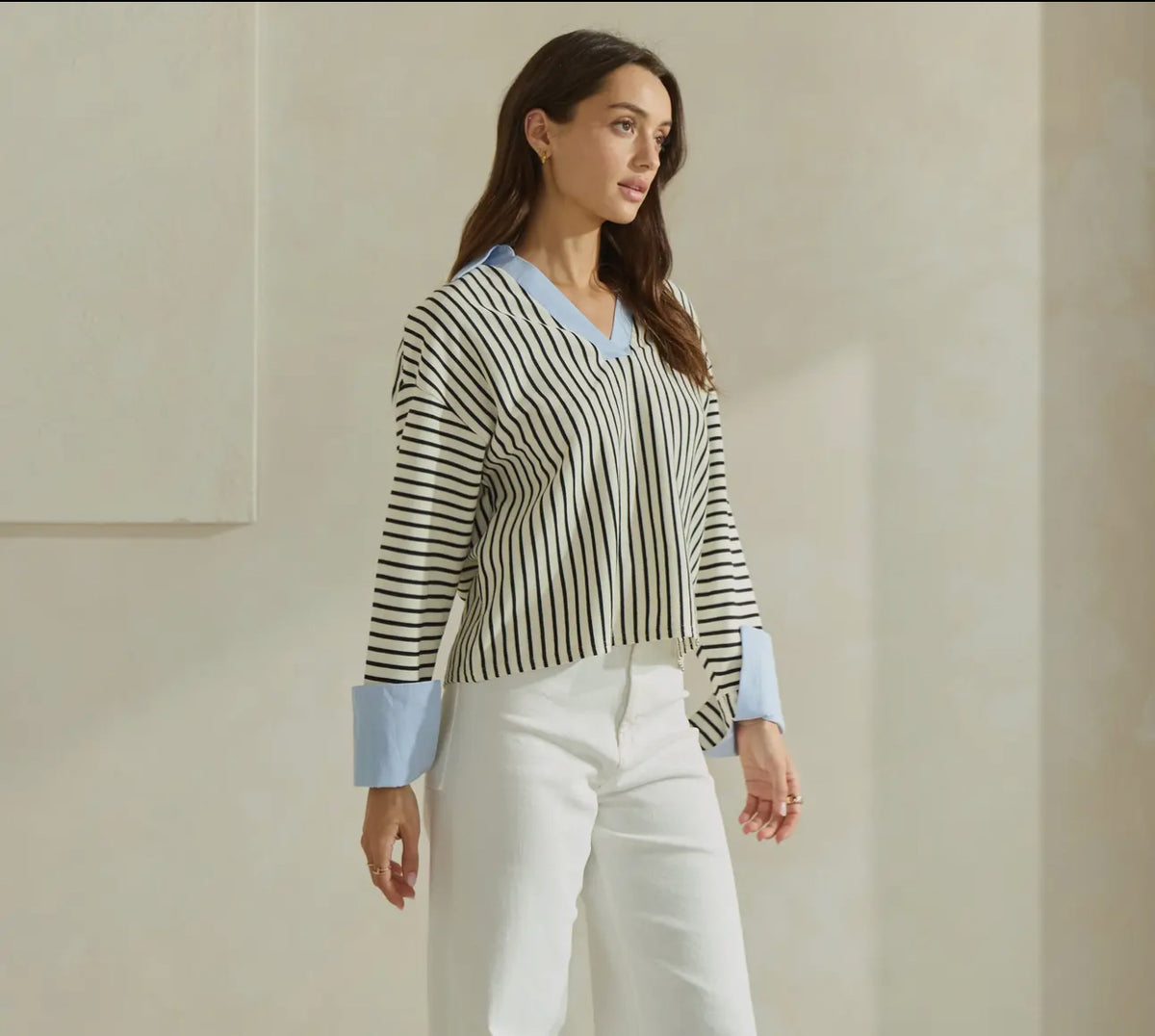 Shirt shown on model paired with white jeans 