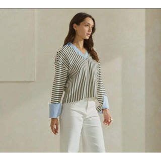 Shirt shown on model paired with white jeans 