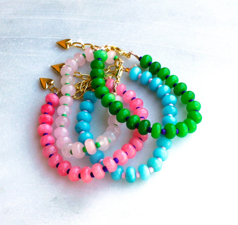 Gorgeous colorful stone candy jade is hand strung to create this beaded bracelet.  Layer these up or wear them alone, they are perfect for a stylish pop of color to your outfits! 
__________________
D E T A I L S

•Colorful jade strung by hand 
•18kt gold filled closure and heart charm
•Available in a 6.5 inch length with a 1.5 inch extender