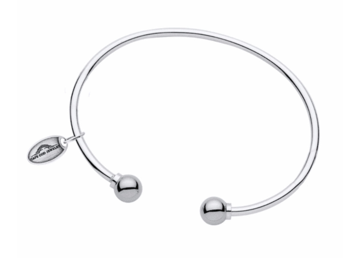 LeStage's genuine Cape Cod Bracelet, with its simple but stylish design is a favorite for all ages!

A unique spin on the classic look -- this cuff features two sterling silver or gold balls on each end.  This bracelet is great to wear alone or add to your Cape Cod Jewelry collection. 

Sterling Silver shown

Made in USA 