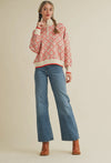 Sweater shown on model paired with neon boots and denim pants 