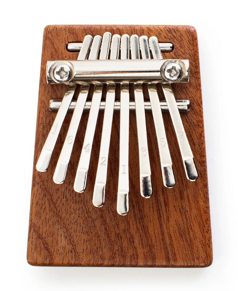 Heard in music around the world, the kalimba creates an unmistakable and ethereal sound. Our pocket-sized version has a sapele wood sound board and 8 steel keys for the best playing experience. Includes sheet music, tuning instructions and a guide. Tune before using.
Design: KDT
Materials: sapele wood, steel
Packaging: color box
Dimensions: 2.75" x 2" x 1" / 7 x 5,3 x 2,7 cm