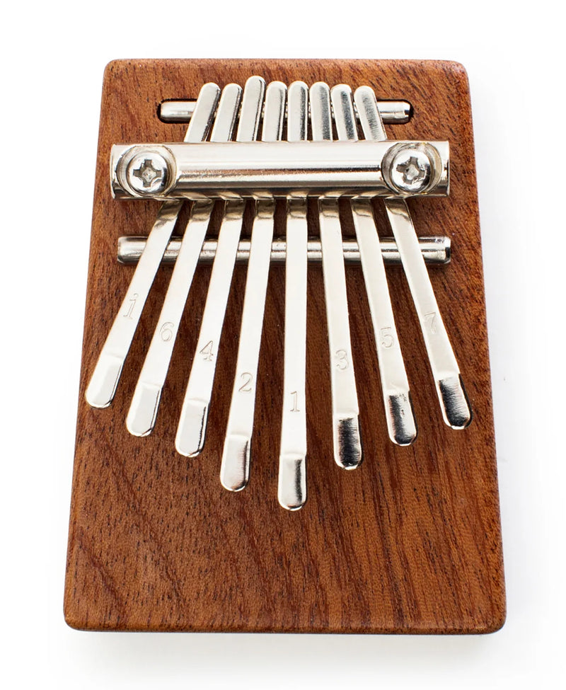 Heard in music around the world, the kalimba creates an unmistakable and ethereal sound. Our pocket-sized version has a sapele wood sound board and 8 steel keys for the best playing experience. Includes sheet music, tuning instructions and a guide. Tune before using.
Design: KDT
Materials: sapele wood, steel
Packaging: color box
Dimensions: 2.75" x 2" x 1" / 7 x 5,3 x 2,7 cm