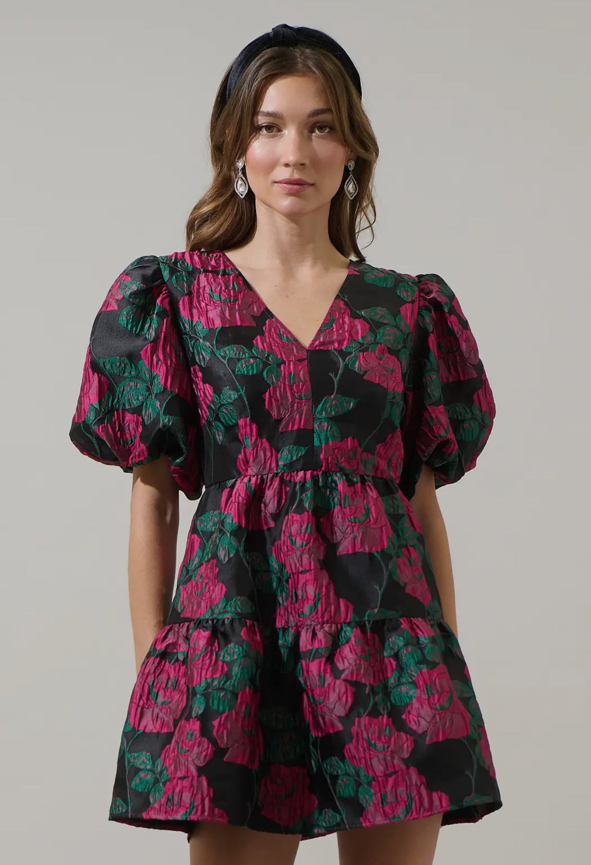 Add a touch of romance to your night with the Farrah Jacquard Floral May Tiered Mini Dress. Floral jacquard fabric shapes this dress with a v-neckline and bubble short sleeves. The open back has a tie string and zipper. Wear it with simple accessories and strappy heels for a finished look.

- Floral
- Jacquard
- V-neck
- Tiered mini 