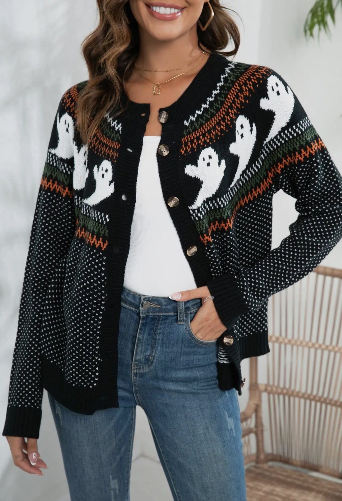 This adorable polka dot ghost cardigan is perfect for Halloween. 

White ghosts  around upper middle with black and white polka dots all over and white and orange lines above and below ghosts. 