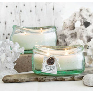 Candle it shown on a table scape 