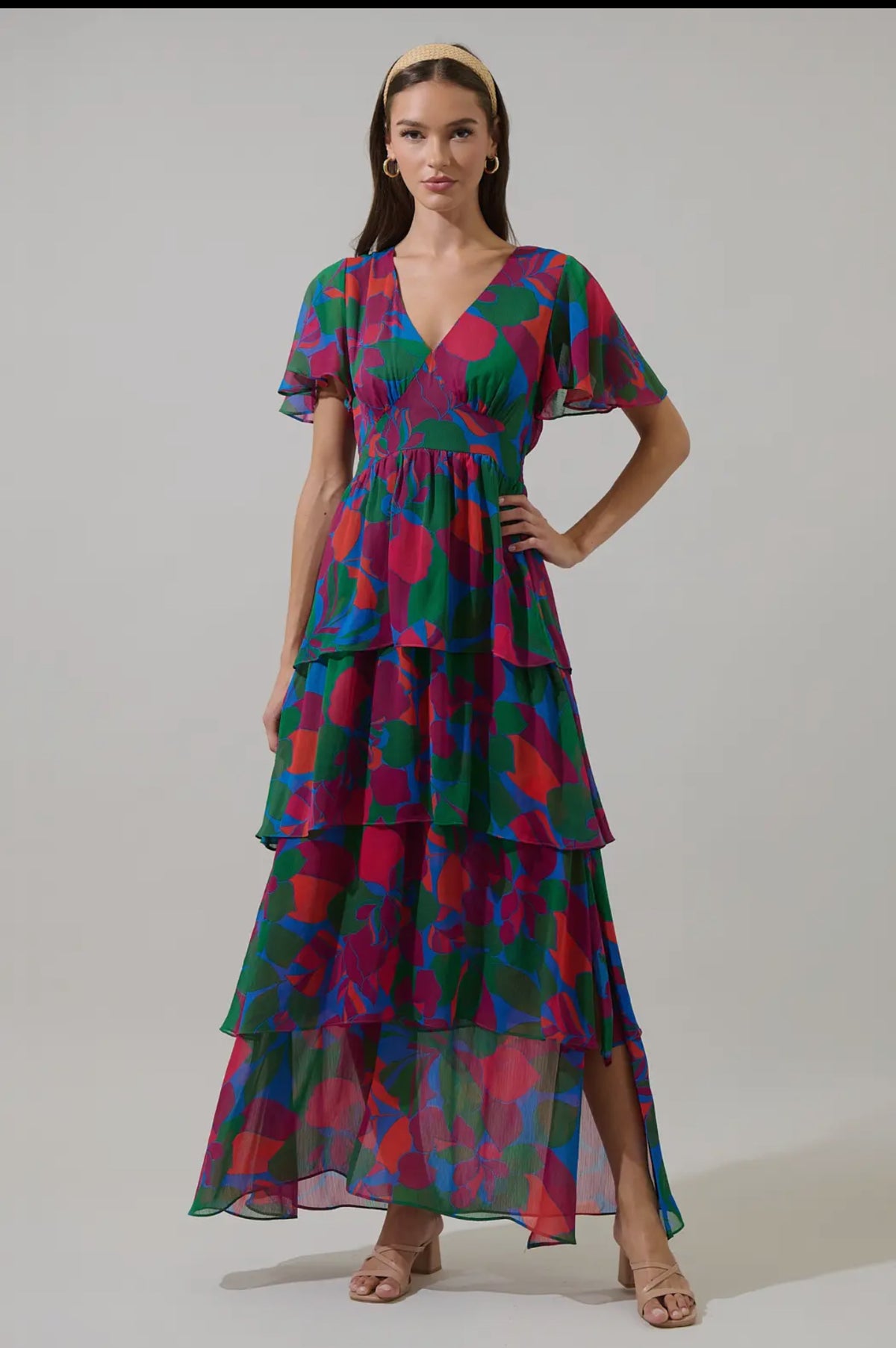 Keep it cute and pretty in the Kaeli Floral Amabel Tiered Maxi Dress. This floral-patterned maxi features a deep v-neck, short sleeves, and a tiered design with a smocked back for a flattering silhouette. Style it with block heels and a delicate clutch for a polished finish.

- Maxi
- Floral
- Deep V-neck
- Tiered
- Color: Magenta Blue Green

Size + Fit
- Model is 5'9" and wearing size XS
- Measurements taken from size S
- Chest: 19"
- Length: 58 1/4"

Fabric

Self: 100% Polyester, Lining: 97% Polyester 3% 