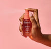 Hand shown spraying tart cherry hair perfume 