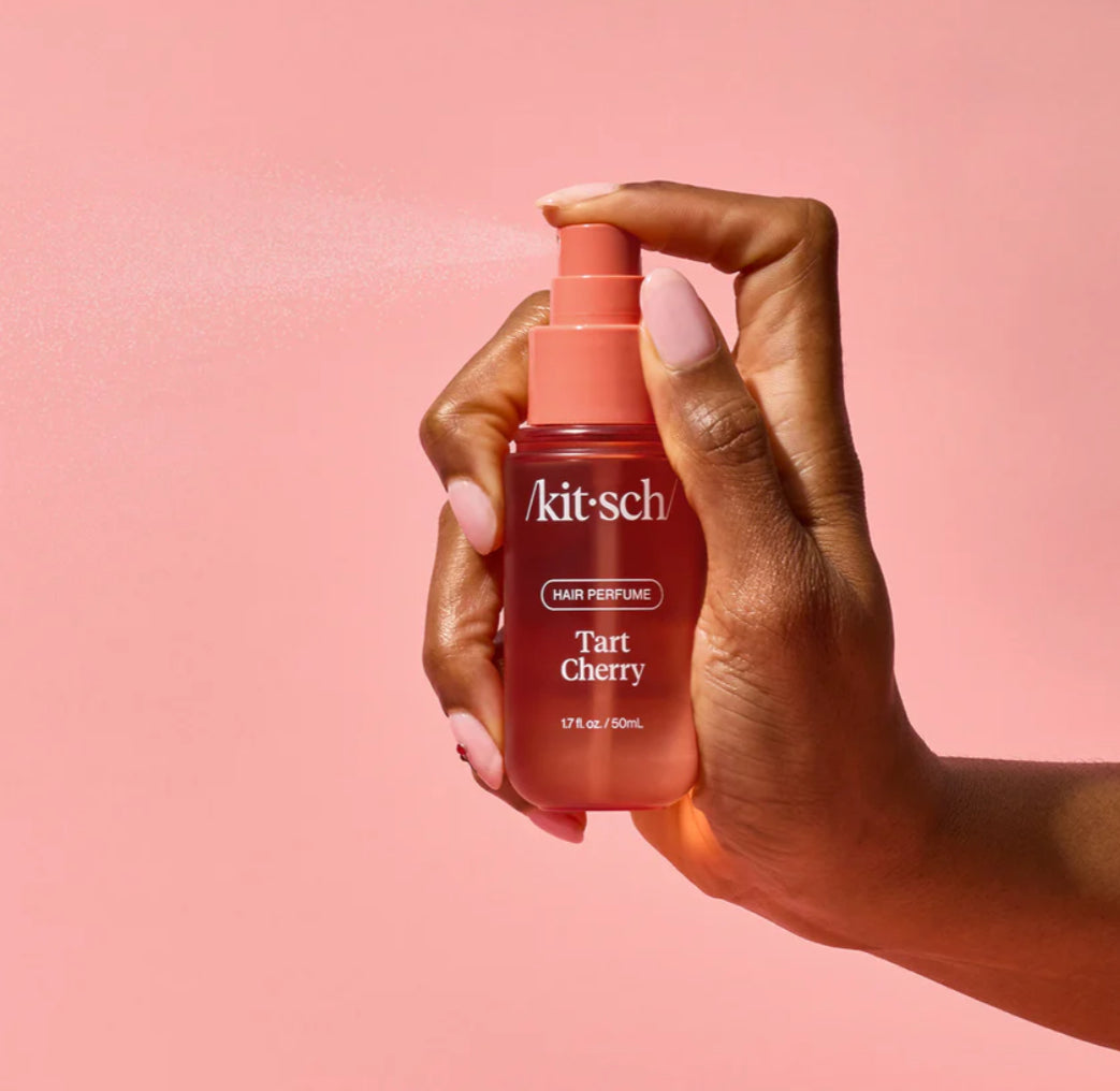 Hand shown spraying tart cherry hair perfume 