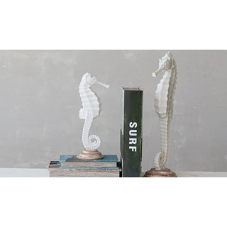Showing both sides a of seahorse state as book ends 

Coastal elegance meets rustic home decor. Sand finished resin seahorses statue on wood base. 12.5” tall large 18” tall