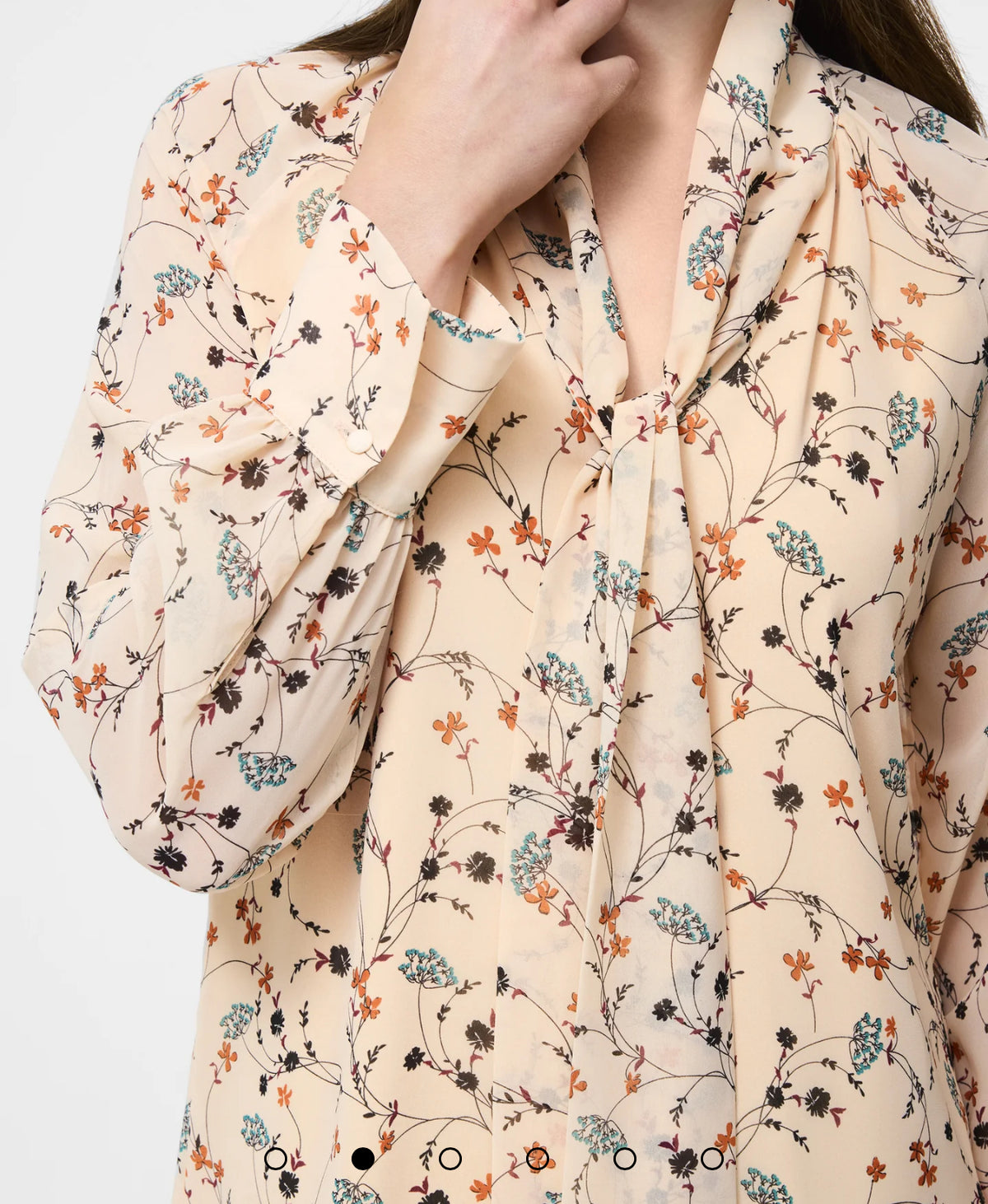 The Leithia Wispy Chiffon Neck Tie Top brings a modern boho feel to your fall lineup. Printed with an autumn-inspired floral on a cream base, it features an airy chiffon silhouette and an attached neck tie you can style your way—bowed, knotted, or left loose. Just add denim or suede and you’re set.

Top
Fabric: airy, lightweight, flowy, floral print, cream + brown
V-neckline
Self tie attached at neck
Long sleeve with flared cuffs
Our model is 5ft7.5" and wears a Size S