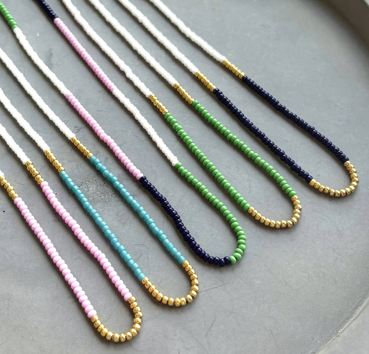 Bright, bold, and full of personality—these multicolor seed bead necklaces are made to stand out. With vivid green, turquoise, and deep navy tones, these handmade pieces bring a splash of joy to any outfit. Whether you're heading to a music festival, beach day, or brunch with friends, this design adds a playful pop of color that totally vibes.
 
Details:
•Vibrant green, lilac, turquoise, and navy seed beads
•Lightweight and comfortable
•Gold filled spring ring clasp 
 
Each piece is handmade, giving it a o