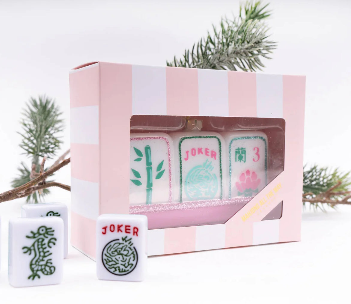 Display your love for mahjong during the holidays with our stunning Mahjong Tile Glass Ornament. We've paid careful attention to detail, crafted from hand-painted imported glass and designed here in the USA. 

 4.5” x 1.5" x 2.5" Glass Hand Painted Boxed for easy gifting! All ornaments come ready to hang with metallic string attached.
