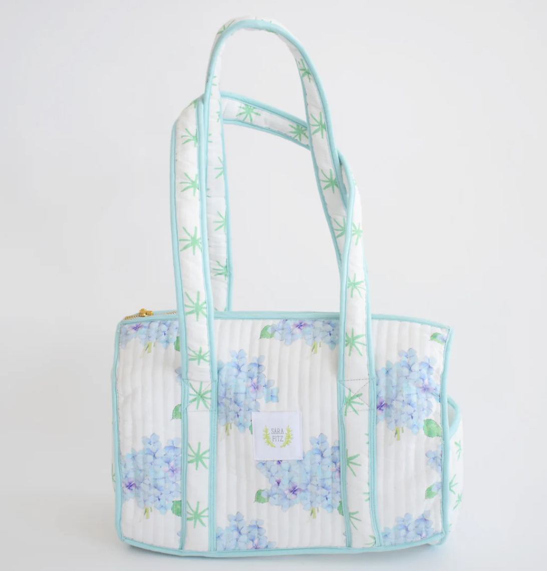 The sweetest shoulder bag with a classic, yet casual spin!  Pair it with the matching coin purse and duffle for a complete set.
100 percent cotton
Quilted texture 
13 inches long | 8 inches high | 7.5 inches deep
15 inch handle drop
Includes interior dual pocket
Mild hand-wash cold, hang dry and warm iron
Made with great care in India
Due to the nature of the printing, you may notice minor imperfections in the fabric.