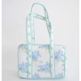 The sweetest shoulder bag with a classic, yet casual spin!  Pair it with the matching coin purse and duffle for a complete set.
100 percent cotton
Quilted texture 
13 inches long | 8 inches high | 7.5 inches deep
15 inch handle drop
Includes interior dual pocket
Mild hand-wash cold, hang dry and warm iron
Made with great care in India
Due to the nature of the printing, you may notice minor imperfections in the fabric.