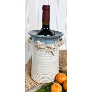 Starfish crock in blue rim with warm tan and creams for bottom with wine bottle 
