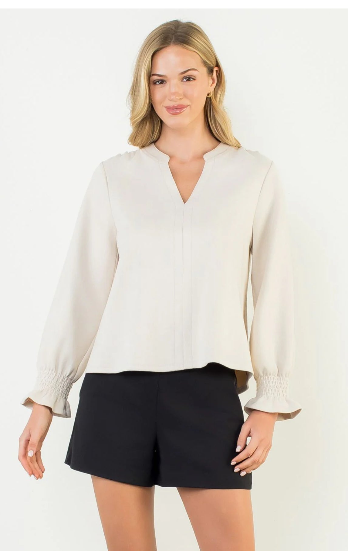 Long sleeve with elastic at the wrist and slight ruffle. V neck