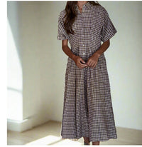 Meet your new go-translational  piece. Cut from breathable woven cotton in a timeless gingham print, this maxi dress is all about easy polish. The collared neckline and button-down front give it that borrowed-from-the-boys vibe, while the short sleeves and subtle waist pin tucks keep it flattering without trying too hard. The flared skirt adds just the right amount of movement (aka it’s twirl-friendly), and since it’s unlined, it feels lightweight and breezy.