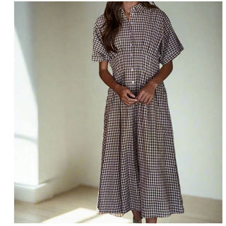 Meet your new go-translational  piece. Cut from breathable woven cotton in a timeless gingham print, this maxi dress is all about easy polish. The collared neckline and button-down front give it that borrowed-from-the-boys vibe, while the short sleeves and subtle waist pin tucks keep it flattering without trying too hard. The flared skirt adds just the right amount of movement (aka it’s twirl-friendly), and since it’s unlined, it feels lightweight and breezy.