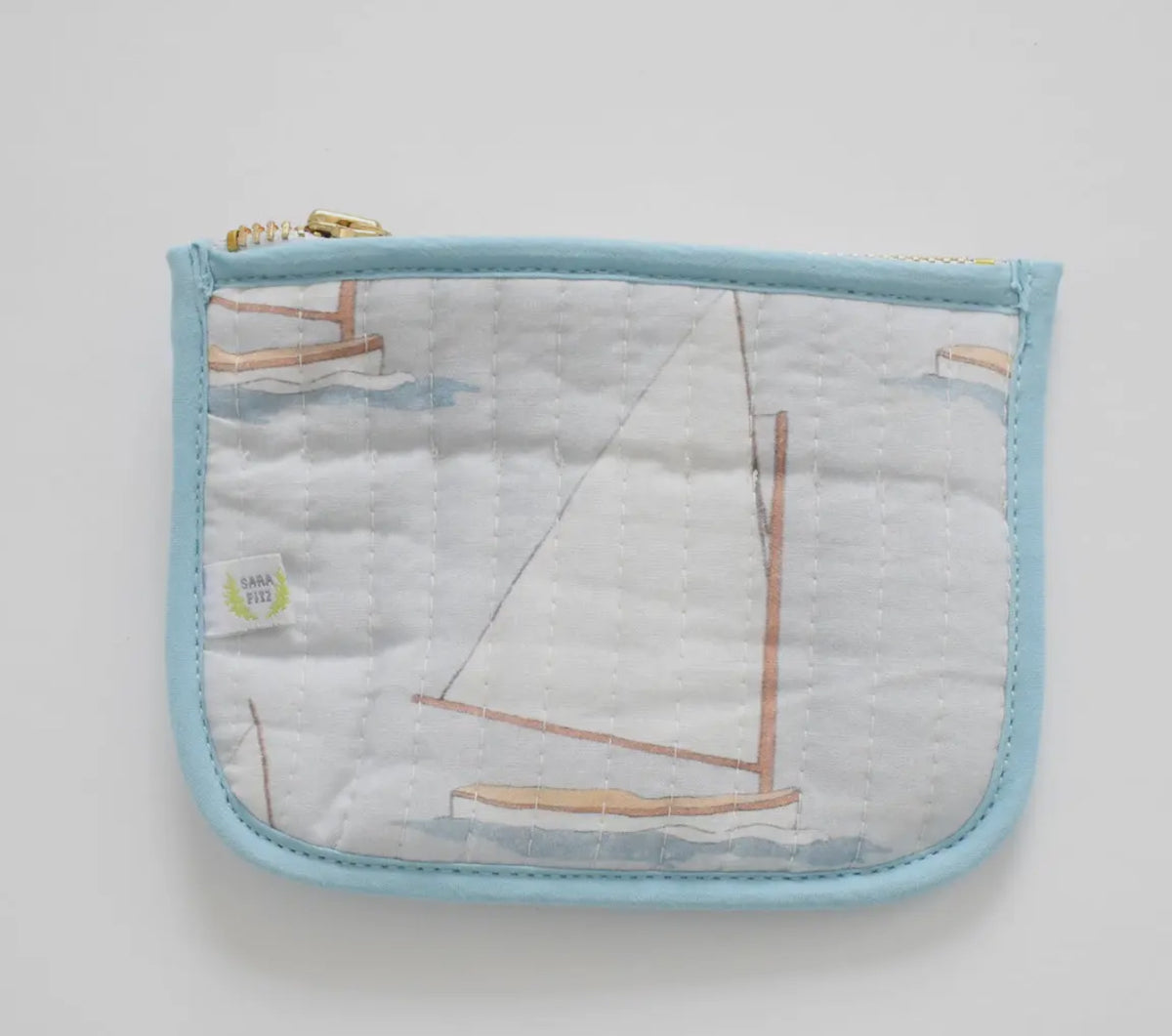 Gah! These little nuggets are the most adorable addition to our bag line! Perfect to hold cards and cash... throw them in any of our other bags! Sailboat shown 

100 percent cotton
Quilted texture 
5.5 inches long | 4 inches high | < 2 inches deep
Zip closure
Mild hand-wash cold, hang dry and warm iron
Made with great care in India
Due to the nature of the printing, you may notice minor imperfections in the fabric.