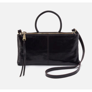 Inspired by our best-selling Sable wristlet,
this crossbody has the signature round
handle you know and love and a removable
strap for two looks in one.  Shown in black 